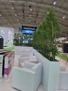 Event Furniture Rental in Riyadh – Successful Booth Setup with TV and Artificial Plants