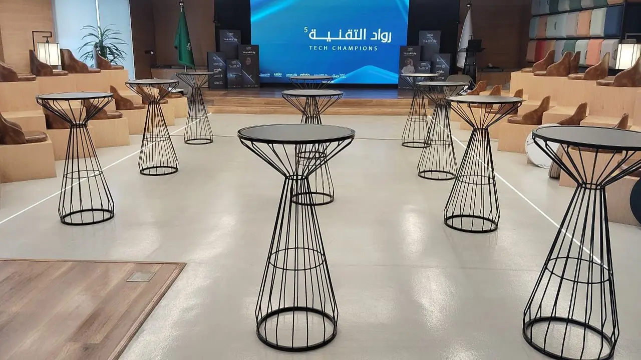Multiple navy cocktail tables with gold accents in a line arrangement