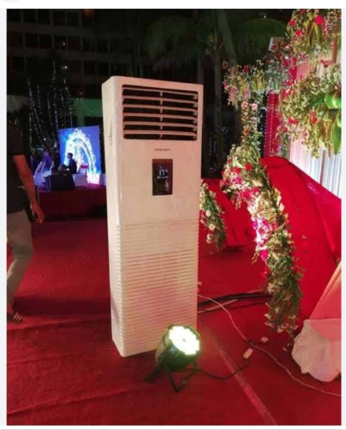 Multiple white industrial air cooling units installed outdoors with solar panels