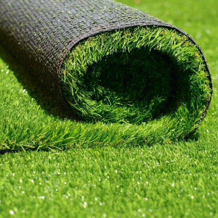 Large residential property with perfect green artificial grass showing complete lawn transformation
