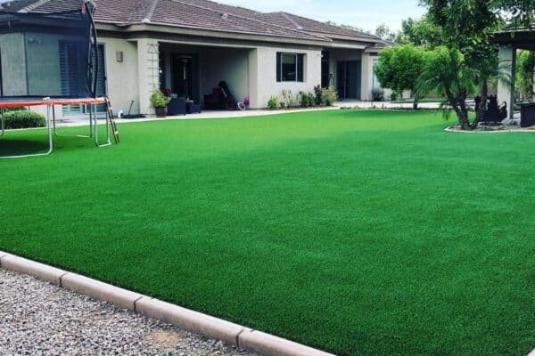 Detailed grass turf roll showing multi-fiber construction and professional installation material