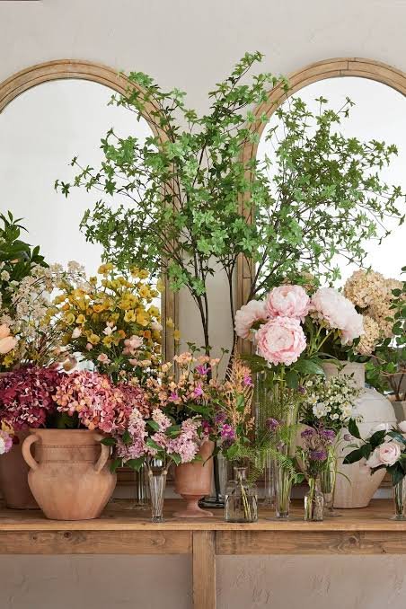 Luxury artificial floral arrangement with purple chrysanthemums pink roses and orange blooms for wedding stage decoration rental Saudi Arabia