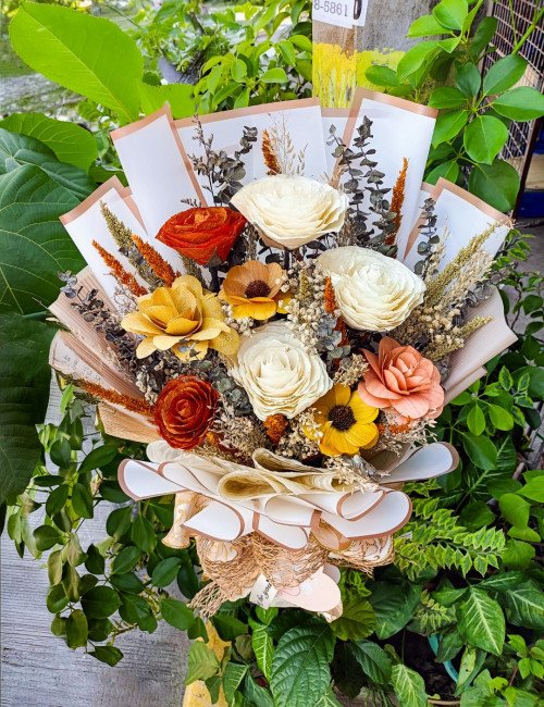 Elegant dried-style artificial flower bouquet with cream roses and autumn tones professionally wrapped for premium event gifting and decor