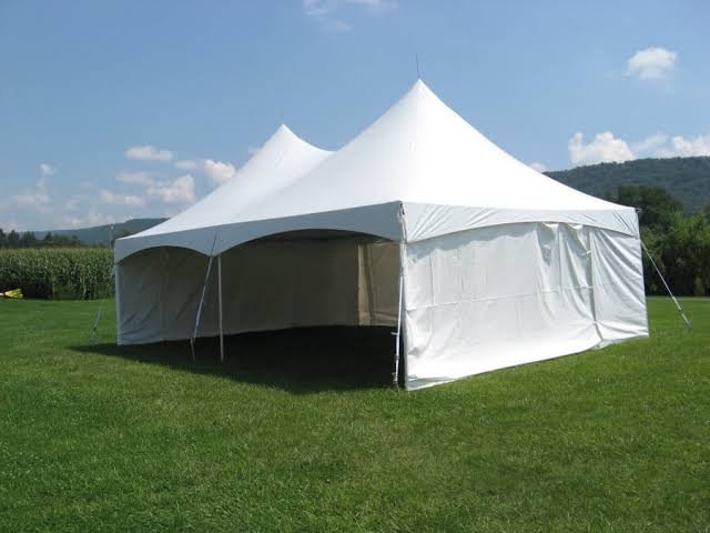 Elegant white canopy with flowing sheer curtains and premium lounging furniture