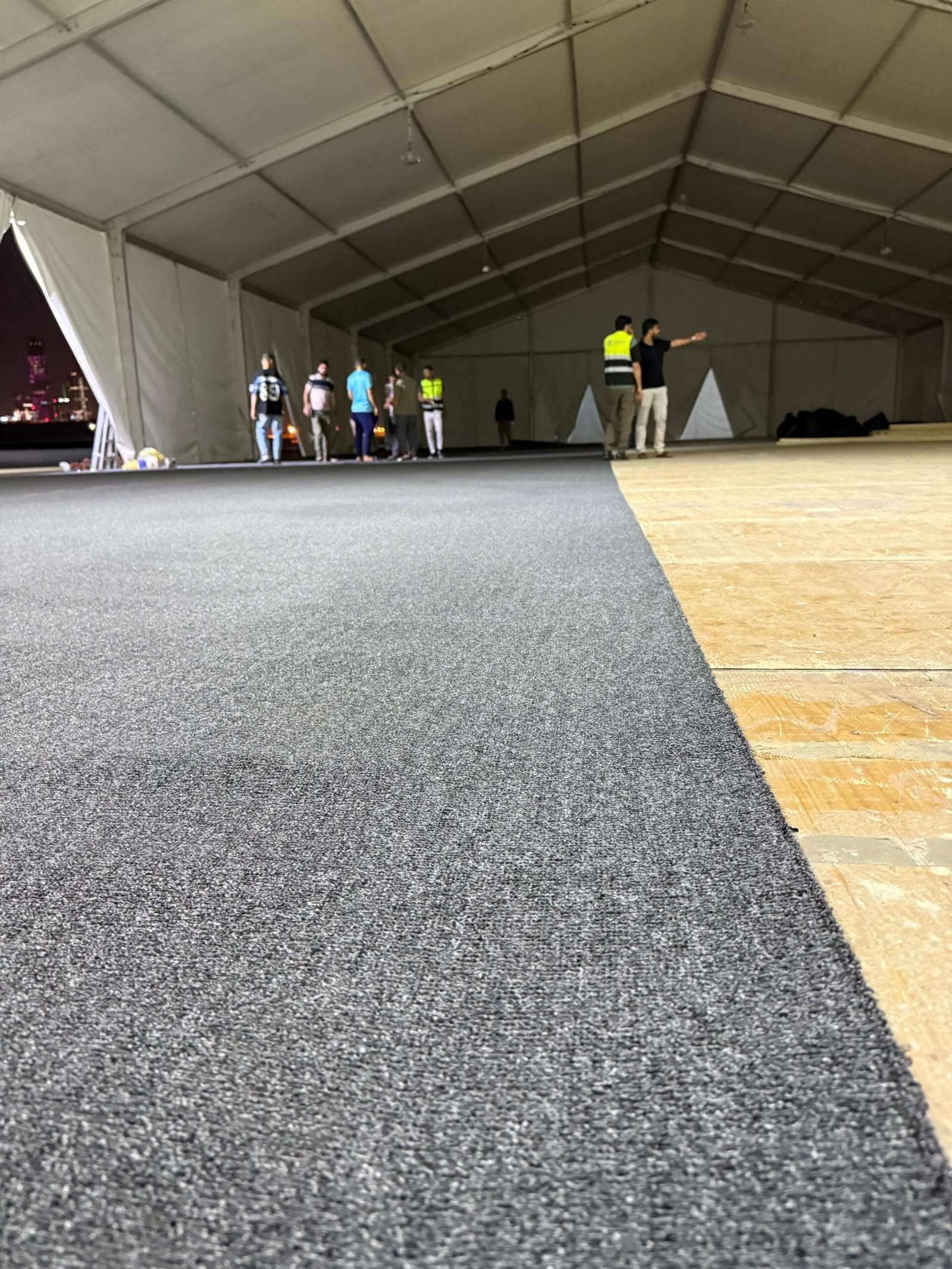 Outdoor venue carpet setup for large event gathering