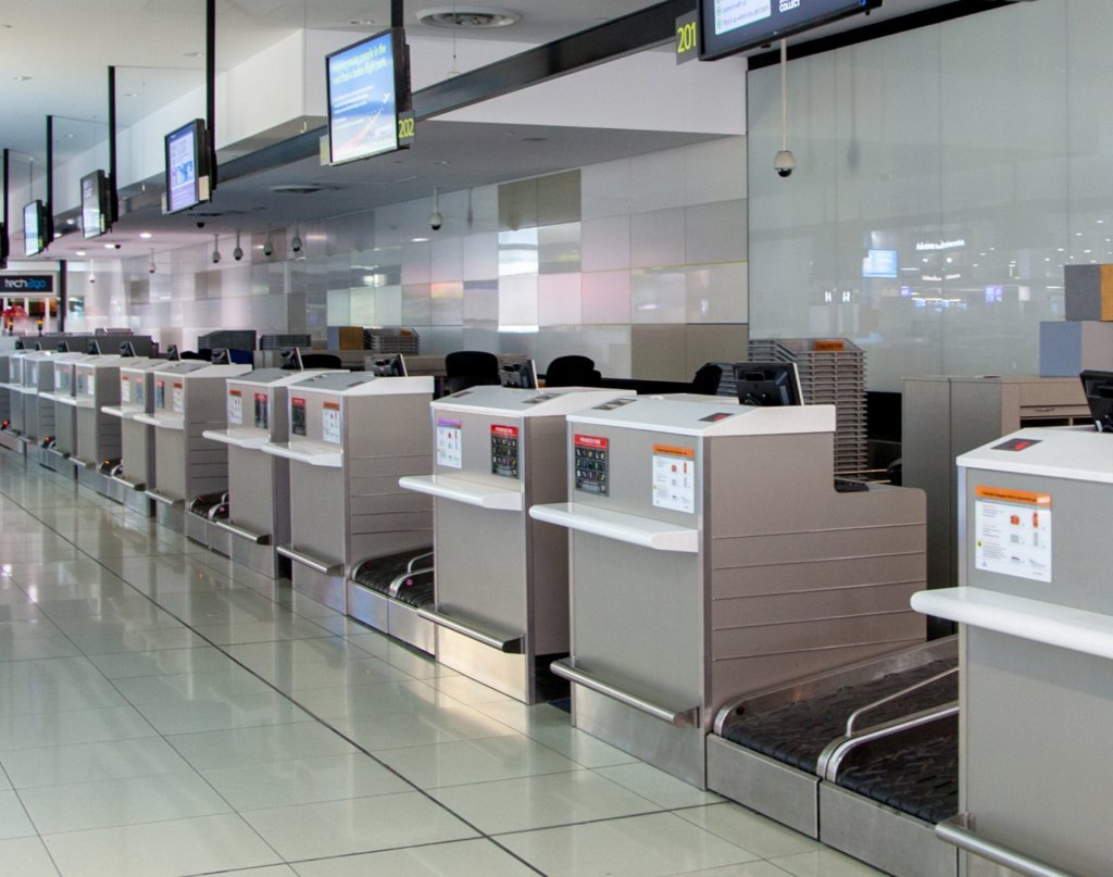 Blue branded check-in counter desks with overhead lane numbers rental KSA