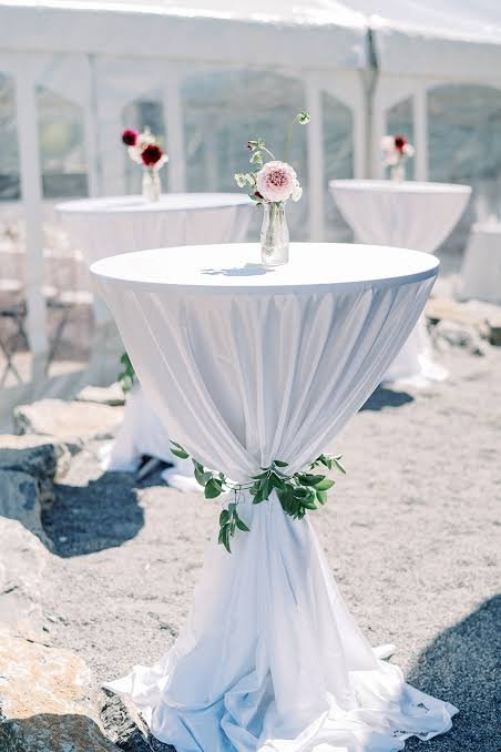 Pink cocktail table with white linen for elegant event