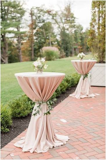 Multiple navy cocktail tables with gold accents in a line arrangement