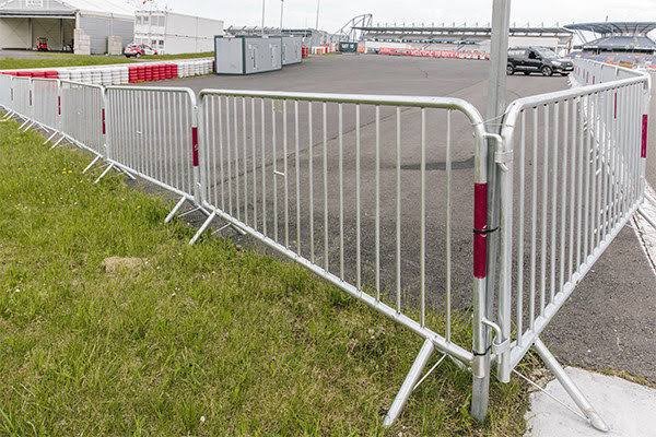 Gray metal crowd control barrier showing heavy-duty construction and professional crowd management design