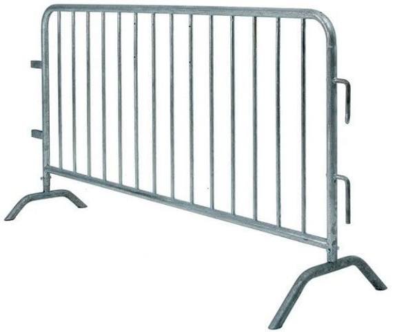 Gray metal barriers in outdoor field showing large-scale crowd control and professional event infrastructure deployment