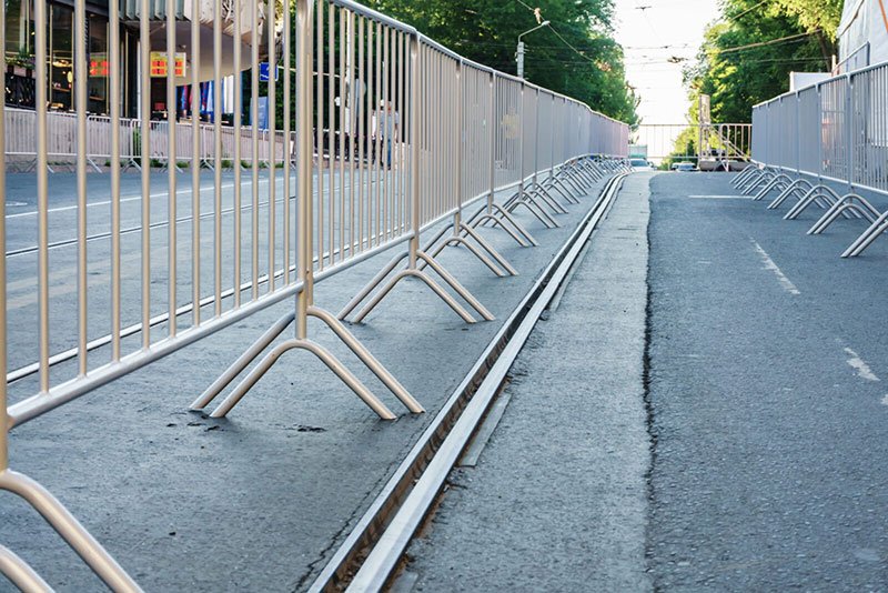 White safety barriers creating defined perimeter area showing effective crowd flow organization and event area definition