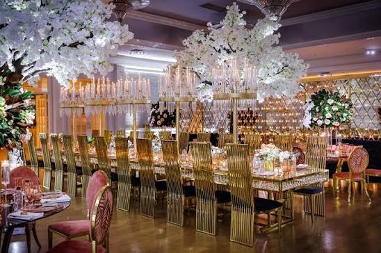 Formal engagement stage with damask gold chairs and blue uplighting rental KSA
