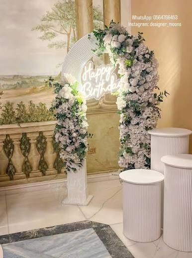 Illuminated festival season entrance gates with themed arch family design at night Saudi Arabia event
