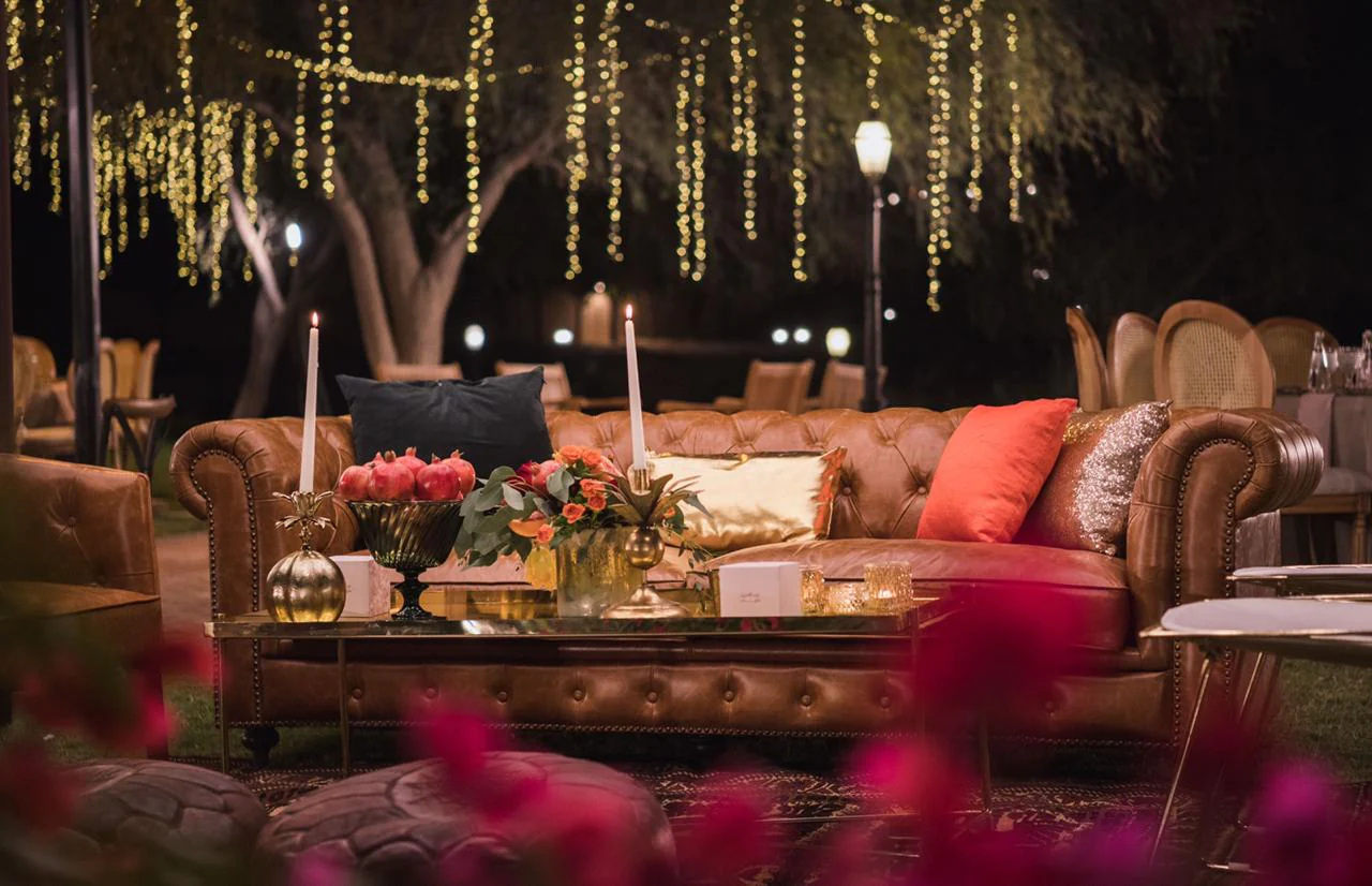Pastel draped indoor kosha stage with gold sofa and floral bouquets Saudi Arabia