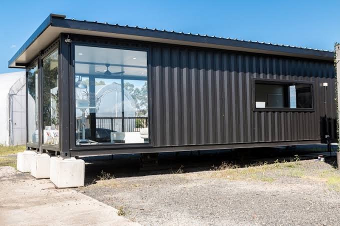 Professional black portable container unit with multiple windows and modern minimalist design