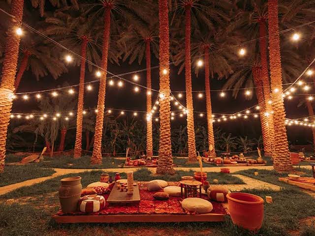 Styled iftar buffet spread with crescent moon decor and brass serveware Ramadan event rental Saudi Arabia