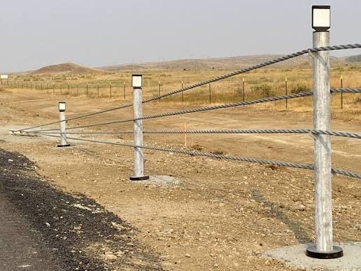 Chrome posts with pink rope barriers forming outdoor queue lines for public event crowd management rental