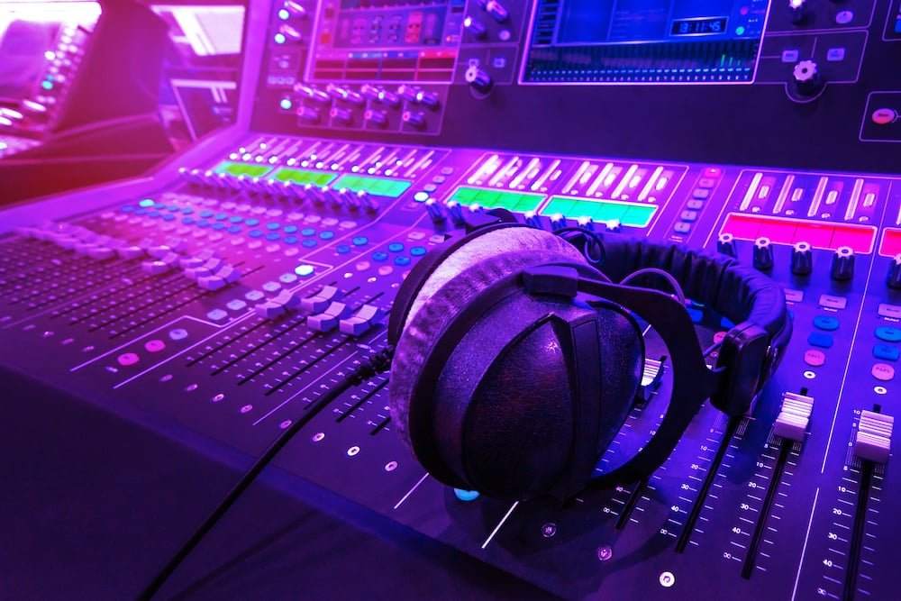 DJ headphones on illuminated audio mixing console speaker rental KSA