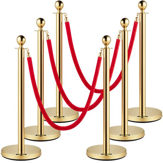 Large inventory of chrome stanchion posts with red velvet ropes ready for event crowd control rental Saudi Arabia
