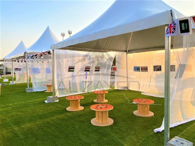 Professional event tent setup with tables and chairs arrangement