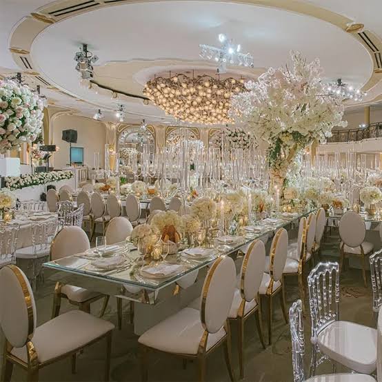 Formal ballroom wedding with round table, white linens, Chiavari chairs and gold accents