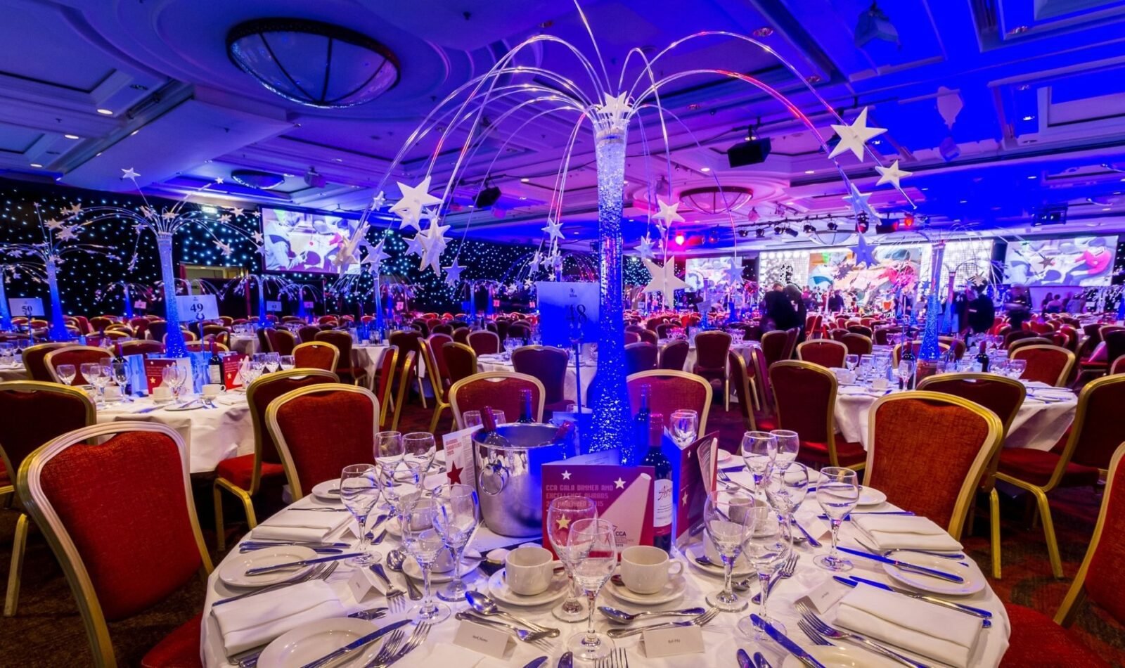 Contemporary launch event with blue branding, demo stations and professional lighting