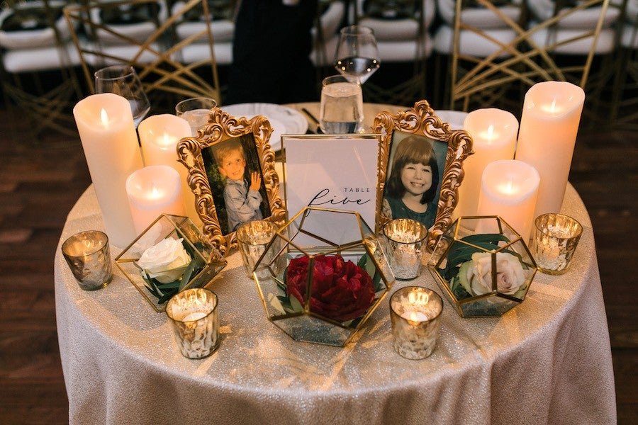 Rustic wedding venue with round tables, cross-back chairs, string lights and blush linens